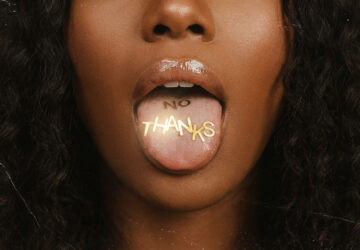-the art of the soft no-woman with tongue out and gold letters that say "no thanks" on her tongue